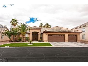 Spacious one-story home featuring a three-car garage and well manicured desert landscaping at 1313 Gallery Oaks Dr, Las Vegas, NV 89123