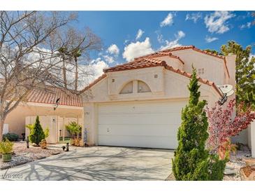 Charming single-Gathering home with a tile roof, two-car garage, and well-maintained landscaping at 1721 Derbyshire Dr, Las Vegas, NV 89117