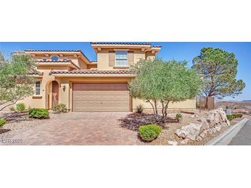 Charming two-story home featuring a tile roof, desert landscaping, and a two-car garage at 21 Via Mantova # 3, Henderson, NV 89011