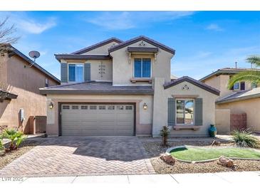 Charming two-story home featuring a two-car garage, complemented by a beautifully designed front yard and desert landscaping at 3925 Kettle Falls Ave, North Las Vegas, NV 89085