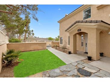 Inviting home exterior featuring a well-maintained lawn and covered entryway at 3950 S Sandhill Rd # 132, Las Vegas, NV 89121