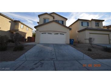 Beige two-story home featuring an attached two-car garage and low maintenance landscaping at 41 Rosa Rosales Ct, North Las Vegas, NV 89031