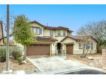 Charming two-story home with a three-car garage and drought-resistant landscaping at 9160 Moose Country Pl, Las Vegas, NV 89178