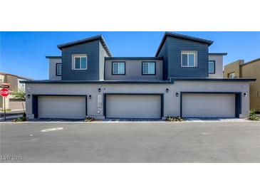 New construction townhomes feature private garages and modern, two-tone exterior paint at 12728 Feathersong St, Henderson, NV 89044