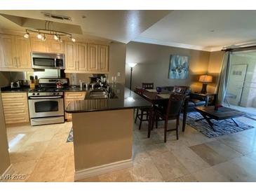 Inviting living room featuring tile flooring, contemporary furnishings, and balcony access at 220 Flamingo Rd # 210, Las Vegas, NV 89169