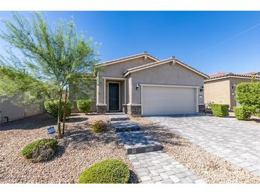 Charming single-story home with a well-manicured front yard and a two-car garage at 221 Mountain Cedar Ct, North Las Vegas, NV 89031
