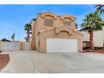 Two-story home featuring a two-car garage, tile roof and desert landscaping at 4431 Palm Mesa Dr, Las Vegas, NV 89120