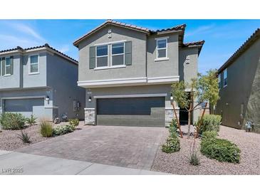 Charming two-story home showcasing a neutral color scheme, two-car garage, and a well-maintained landscaped yard at 4588 Swimming Minnow Ave, Las Vegas, NV 89141
