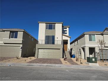 A modern two-story home featuring a balcony and a two-car garage, set against a clear blue sky at 5748 Avondale Rise Way, Las Vegas, NV 89141