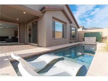 Inviting pool featuring in-pool lounge chairs, perfect for relaxation and enjoying the outdoors at 8648 Cloverbelle St, Las Vegas, NV 89166