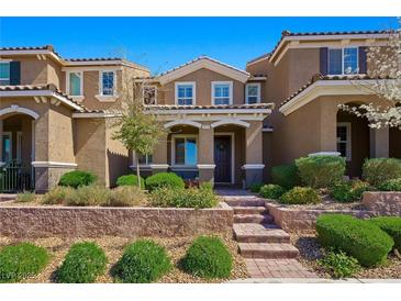 Charming two-story home with landscaped yard and brick steps to covered porch at 2816 Turnstone Ridge St, Henderson, NV 89044