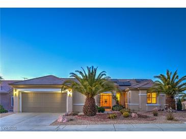 Charming single-story home featuring a desert landscape, two-car garage, and a welcoming front entrance at 3002 Hickory Valley Rd, Henderson, NV 89052