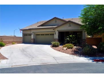Charming single-story home featuring a three-car garage and well-maintained landscaping at 4047 Cougar Falls Ct, North Las Vegas, NV 89085