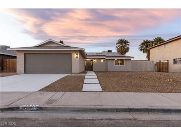 Charming single-story home with a two-car garage, desert landscaping, and freshly poured concrete walkway at 4842 Plata Del Sol Dr, Las Vegas, NV 89121