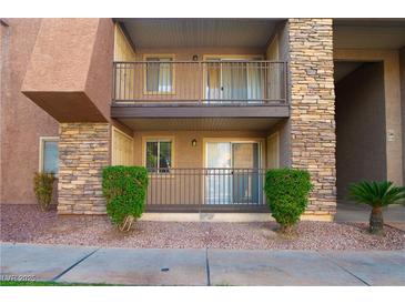 Condo exterior with stone accents, balcony, well-maintained landscaping, and pathway at 5000 Indian River Dr # 475, Las Vegas, NV 89103