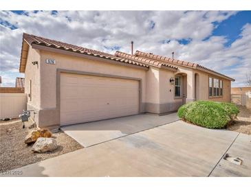 Charming single-story home featuring a tile roof, two-car garage, and well-maintained landscaping at 576 Bayo Canyon Ct, Henderson, NV 89015