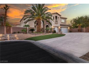 Elegant two-story home with a spacious driveway, well-manicured landscaping, and attached two car garage at 6214 Ebony Legends Ave, Las Vegas, NV 89131