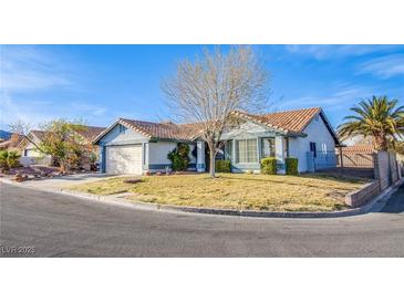 Charming single-story home featuring a well-maintained lawn, desert landscaping, and a two-car garage at 819 Teal Wing Way, Henderson, NV 89002