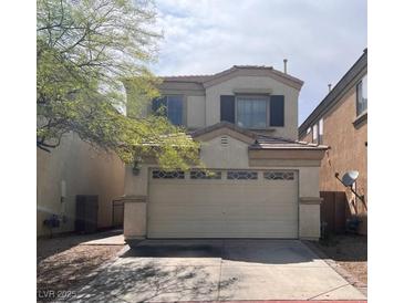 Charming two-story home features a well-maintained lawn and attached two-car garage at 8301 Strawberry Spring St, Las Vegas, NV 89143