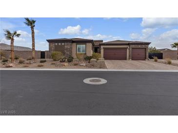 Beautiful single-story home featuring a three-car garage and manicured desert landscaping at 9035 Chiffon Mist Ave, Las Vegas, NV 89129