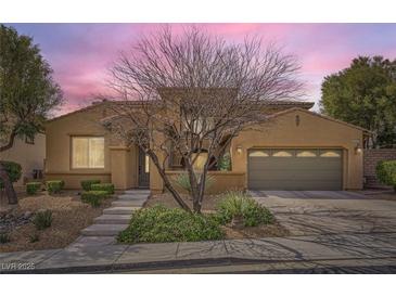 Charming single-story home with a two-car garage, landscaped front yard, and a desert-friendly design at 12277 Bluebird Canyon Pl, Las Vegas, NV 89138