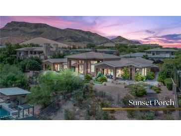 Expansive home with desert landscaping, sunset views, and seamless indoor/outdoor living at 23 Quiet Moon Ln, Las Vegas, NV 89135