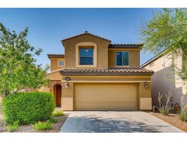 Charming two-story home featuring a tile roof, tan stucco exterior, and a two-car garage at 257 Via Franciosa Dr, Henderson, NV 89011
