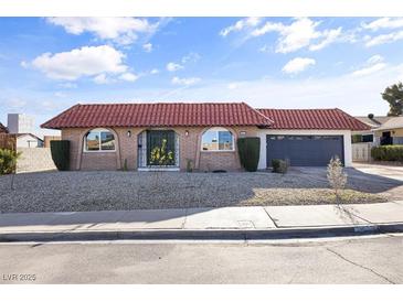 Charming single-story home with a red tile roof and a desert-landscaped front yard at 3672 Madrid St, Las Vegas, NV 89121