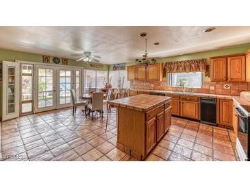 Spacious kitchen featuring tile flooring, wooden cabinetry, and a center island, perfect for cooking and entertaining at 4730 Mountain Valley Rd, Las Vegas, NV 89121