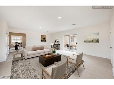 Bright, airy living room with neutral tones, stylish furniture, and sliding glass doors to outdoor space at 4790 E Cleveland Ave, Las Vegas, NV 89104