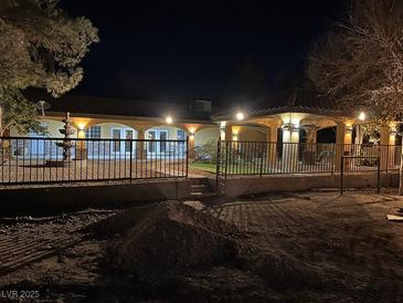 An ornate fountain and covered patio provide a relaxing backyard retreat at 6151 Whispering Sands Dr, Las Vegas, NV 89131