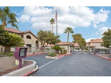 Exterior view of a gated community entrance with manicured landscaping and common areas on a clear, sunny day at 2606 S Durango Dr # 287, Las Vegas, NV 89117