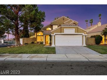 Charming two-story home featuring manicured landscaping, a spacious two-car garage, and desert style xeriscaping at 3024 Half Shell Way, Las Vegas, NV 89128