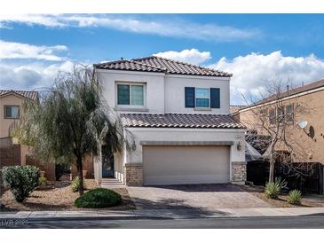 Charming two-story home with a desert landscape, brick driveway, and two car garage at 369 Monique Springs St, Henderson, NV 89014