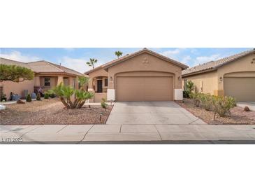 Charming single-story home featuring a two-car garage, well-manicured landscaping, and a cozy front porch at 5991 Saddle Horse Ave, Las Vegas, NV 89122