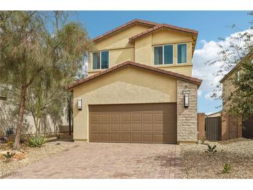 Inviting two-story home featuring a two-car garage and low-maintenance desert landscaping at 6622 Palm Branch St, North Las Vegas, NV 89086
