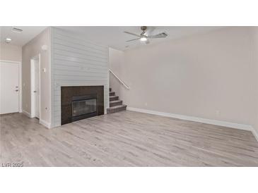Bright living room features modern flooring, fireplace, and stylish ceiling fan for comfortable living at 6712 Biltmore Garden St, Las Vegas, NV 89149
