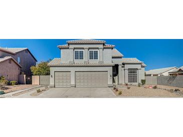 Stunning two-story home with a three-car garage and manicured landscaping at 7900 Holly Knoll Ave, Las Vegas, NV 89129