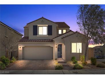 Charming two-story home featuring a brick driveway, manicured landscaping, and a neutral color scheme, perfect for curb appeal at 8106 Skye Glen St, Las Vegas, NV 89166