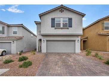 Charming two-story home with a brick driveway and a two-car garage at 9983 Cluny Ave, Las Vegas, NV 89178