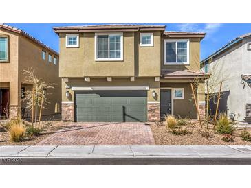 Charming two-story home featuring a two-car garage and modern architectural details at 10778 Hickam Ave, Las Vegas, NV 89129