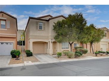 Charming two-story home with a well-manicured front yard and attached garage in a quiet neighborhood at 11092 Abbeyfield Rose Dr, Henderson, NV 89052