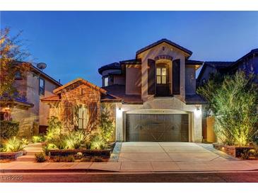 Charming two-story home with a stone-accented facade and a well-maintained front yard at twilight at 11221 Stanwick Ave, Las Vegas, NV 89138