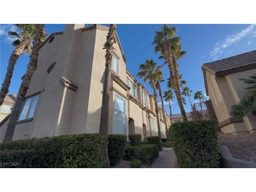Lovely multi-story home with desert landscaping and palm trees under a beautiful blue sky at 1505 Couples St, Las Vegas, NV 89128