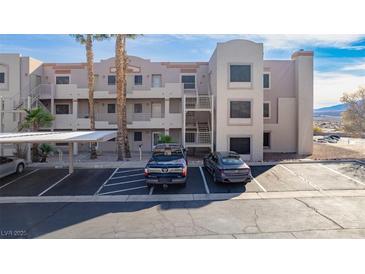 Modern condo building showcasing well-maintained landscaping and ample parking with carports at 2068 Mesquite Ln # 203, Laughlin, NV 89029