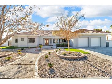 Beautiful single-story home featuring a tile roof and a well-manicured yard with mature landscaping at 60 E Levi Ave, Las Vegas, NV 89183