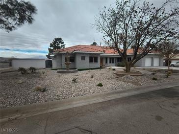 Charming single-story home with desert landscaping, fountain, and red tile roof at 60 E Levi Ave, Las Vegas, NV 89183