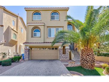 Attractive two-story home showcasing a meticulously maintained lawn and a private two-car garage at 1009 Ancient Timber Ave, Henderson, NV 89052