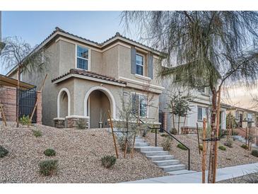 Charming two-story home features a landscaped yard and inviting arched entryway at 1328 Graphite Ave, Henderson, NV 89002