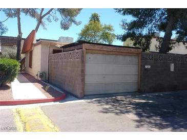 A detached one car garage featuring a block wall and concrete driveway at 3946 Voxna St, Las Vegas, NV 89119